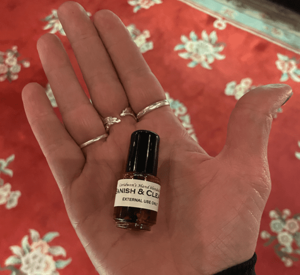 Banish and Cleanse Oil Bottle on The Palm of a Person