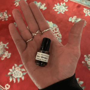 a tiny bottle of Bat Spirit Oil on the palm of a person