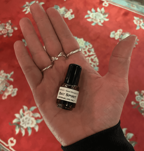 a tiny bottle of Bat Spirit Oil on the palm of a person