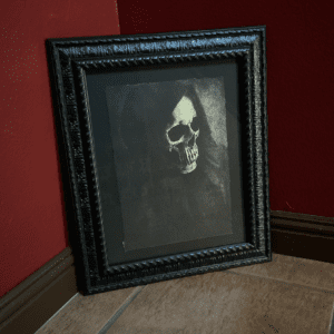 image of a shrouded skull printed on handmade paper