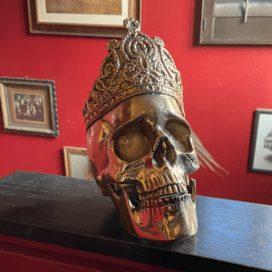 Anatomical skull with a crown cast from brass