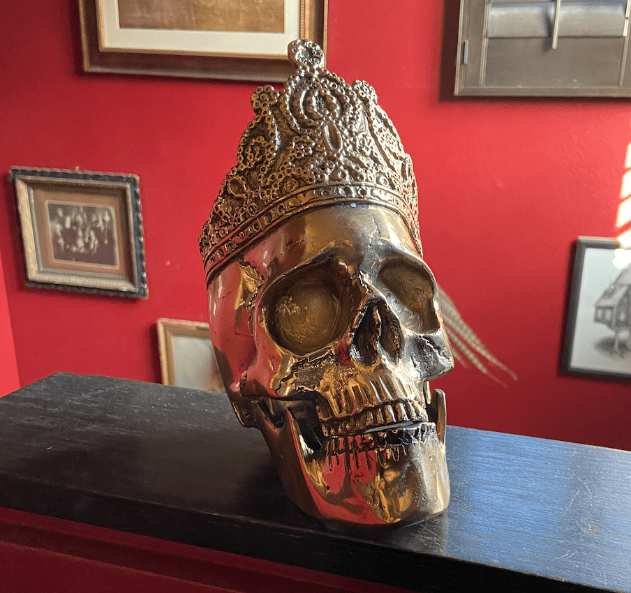Anatomical skull with a crown cast from brass